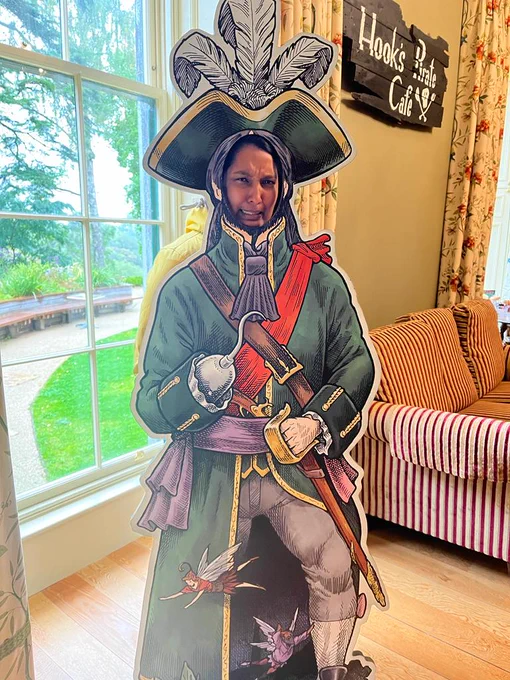 A woman peeking through a pirate photo stand-in