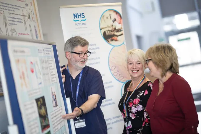 A School of Medicine staff member at the University of Dundee showcases an exhibit