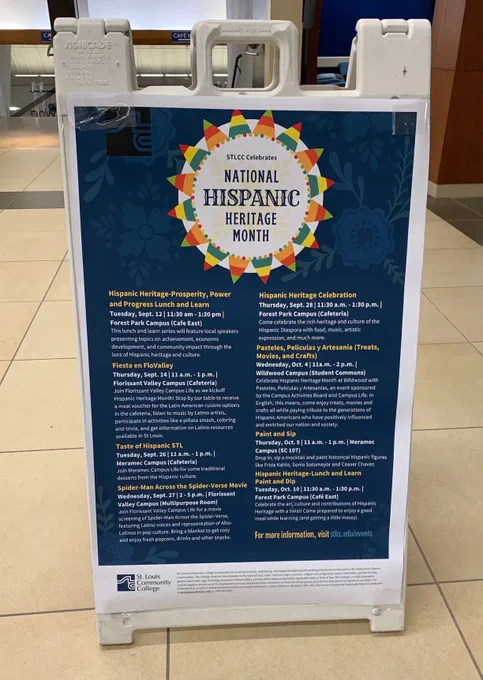 White sign board with blue background and a circle with the words National Hispanic Heritage Month and a listing of events at each STLCC campus.
