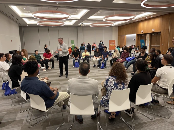 Students sit in a circle.