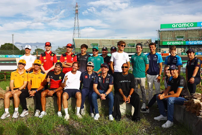 A photo of all the F1 drivers sat with Sebastian Vettel at the inside of Turn 2 in Suzuka
