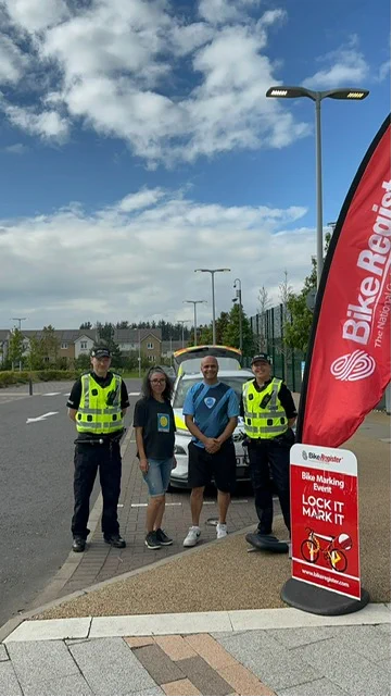 An image of community Police with members of the Maidenhill community at a bike marking event.
