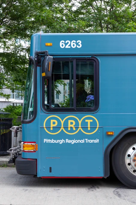 Front end of teal PRT branded bus