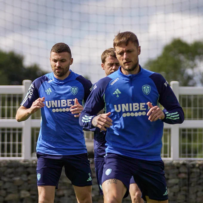 Liam Cooper, Stuart Dallas and Patrick Bamford are pictured warming up ahead of training at Thorp Arch