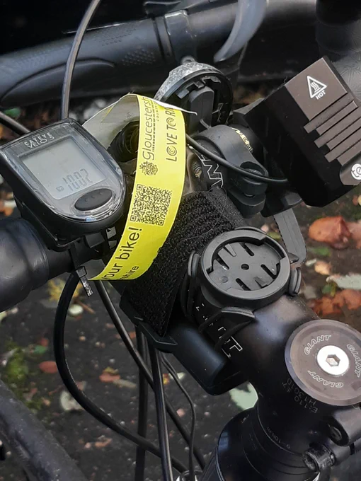 A Love to Ride band has been attached to the handlebars of a bike at Cheltenham Spa Station. 
