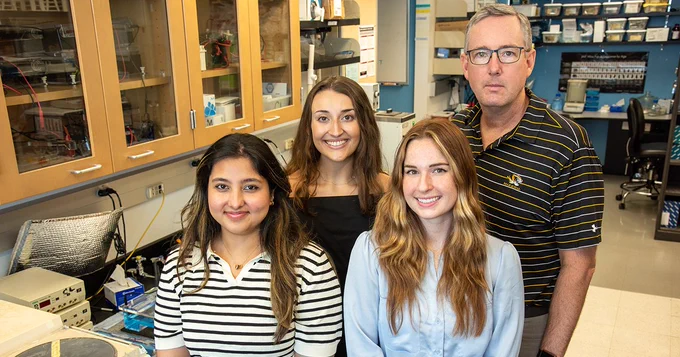 Left to right: Shift Pharmaceuticals research specialists Tanishka Kuhrani, Leah Lepore and Juliette Baker work with investigator Chris Lorson at the Bond Life Sciences Center.