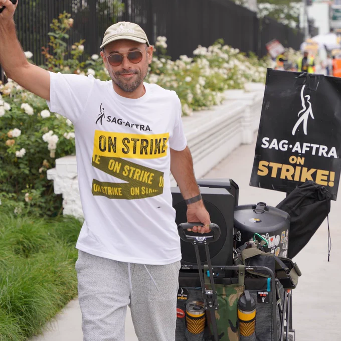 A Sag-Aftra member pulls a wagon behind him as he walks the picket line. 