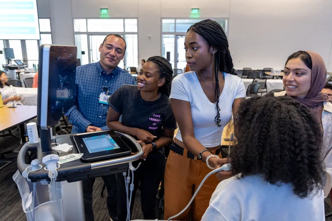 Medical students learn how to use an ultrasound