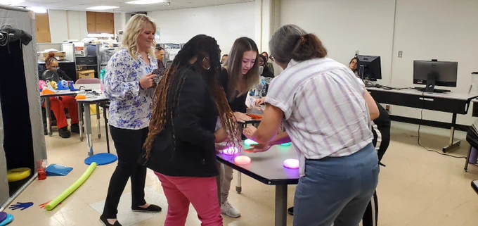 Myself w/ 4 occupational therapists and physical therapists playing an intense game of showdown on the Cosmo app w/ their blue tooth switches that light up bright colors