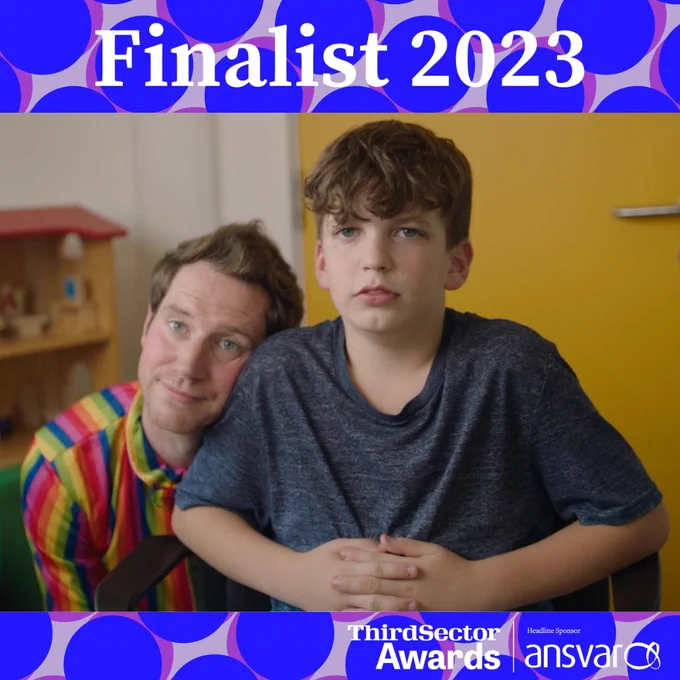 A still of Elliott and Ed MacArthur from our short film Me & My Stammer. Elliott is sat on a chair and looking into the camera. Ed is crouched down and resting his head on Elliott. There is a yellow door behind them.

The headline atop reads: Finalist 2023. Logos for the Third Sector Awards and Ansvar are below.
