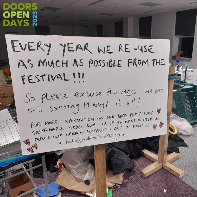 Doors Open Day - photo of a sign in our office explaining how we re-use as much as possible every year which is why the place is a bit of a mess. Get in touch hello@hiddendoorarts.org if you'd like to know more about our sustainability as a festival.