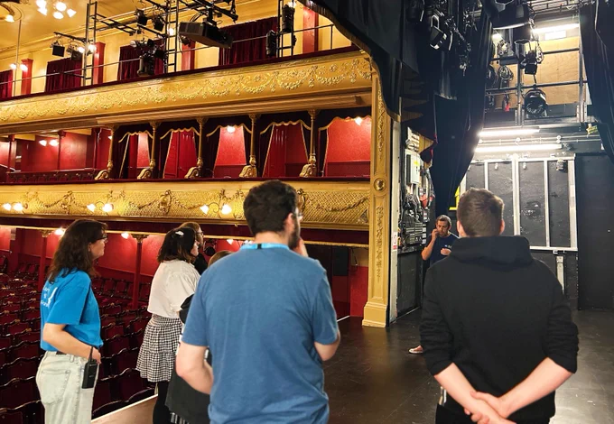 Students are instructed on stage at City Varieties Music Hall.
