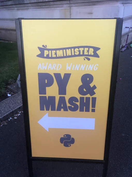 An advertising board from Pieminister saying “award winning py & mash” where pie is misspelled p-y.