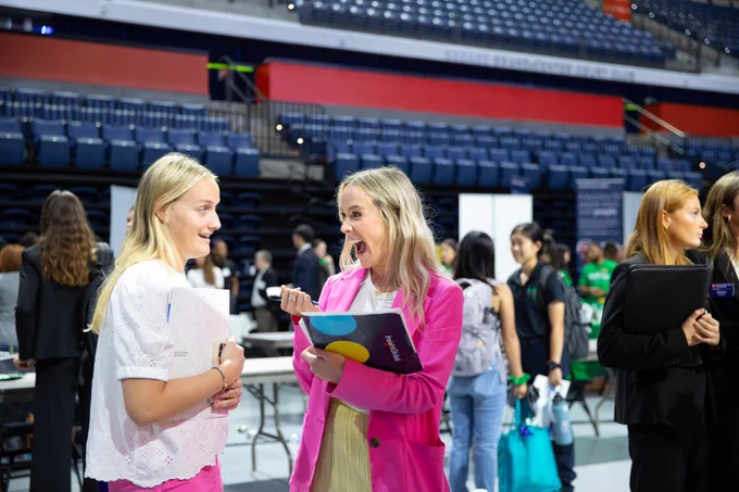 A recruiter is very excited when speaking with another UF candidate.