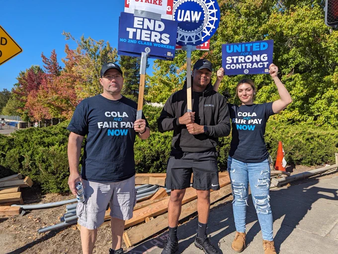 Three Local 492 members with signs