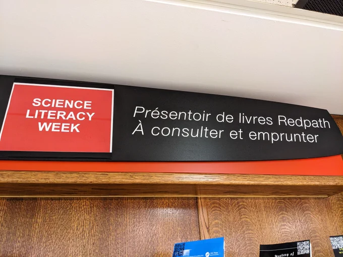 Installation view of Science Literacy Week book display showing sign that says "Science Literacy Week."