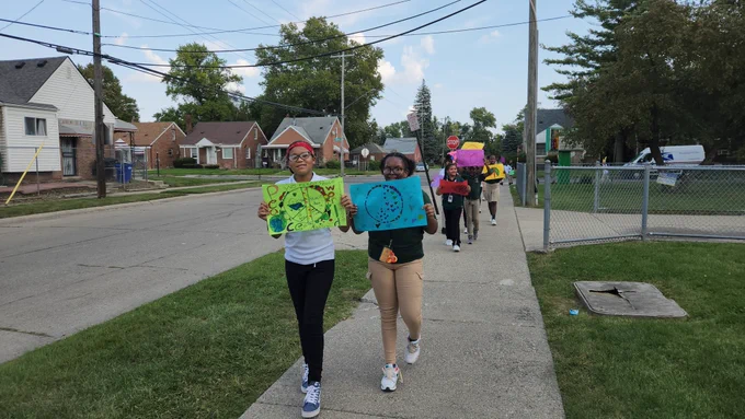 Students with signs march in celebration of world peace day