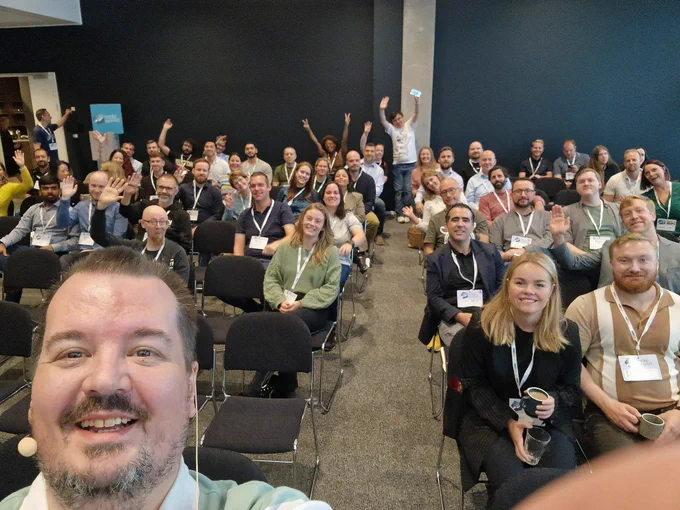 A smiling Mike in front of a room full of people! 