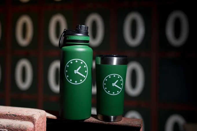 An image promoting the Obvious Shirts x Cubs giveaway displaying two Obvious Shirts 1:20 clock water bottle and tumbler.