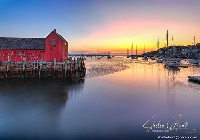 Colorful sunrise at Motif Number 1, a breathtaking sight... Located on Cape Ann in the coastal town of Rockport, Massachusetts, Motif Number 1 is a simple wooden fishing shack, painted a vibrant shade of red, an icon in the little fishing village. This beautiful long exposure photograph is calm and relaxing and shows the peaceful harbor of Rockport. This artwork is from the Fine Art Gallery of Shelia Hunt.