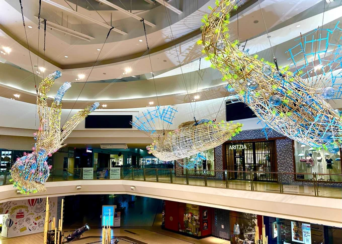Space vessels made of bamboo and discarded plastics hanging from the ceiling.