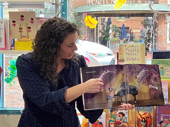 Reading the concert spread of the book. Anita’s letter art reads “Swell… ripple… flow…”