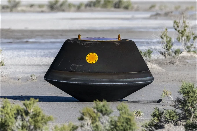 The sample return capsule from NASA’s OSIRIS-REx mission is seen shortly after touching down in the desert, Sunday, Sept. 24, 2023, at the Department of Defense's Utah Test and Training Range. The sample was collected from the asteroid Bennu in October 2020 by NASA’s OSIRIS-REx spacecraft. Photo Credit: (NASA/Keegan Barber)