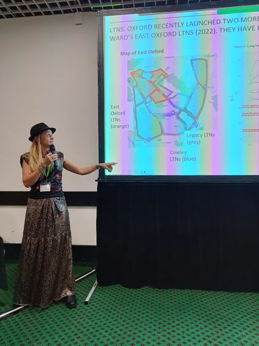 Woman in hat showing slide of LTNs in Oxford 