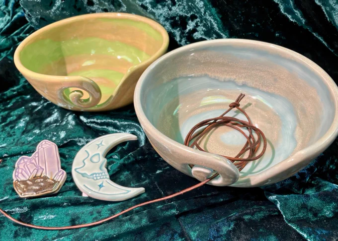 picture of 2 yarn bowls with leather cord and a blue moon magnet and purple crystal magnet