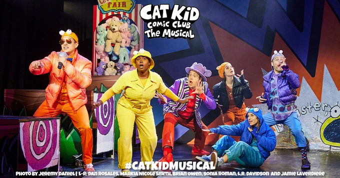 6 performers standing on a colorful stage. They all are wearing different color outfits. There is text on the top of the photo that reads "Cat Kid Comic Club The Musical". There is text towards the bottom of the photo that reads "#CatKidMusical Photo by Jeremy Daniel | L-R: Dan Rosales, Markia Nicole Smith, Brian Owen, Sonia Roman, L.R. Davidson and Jamie Laverdiere"