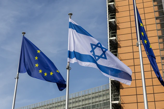 The European and the Israeli flags flying side by side in front of the Berlaymont building in Brussels