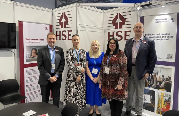 Photo of HSE employees stood on an exhibition stand