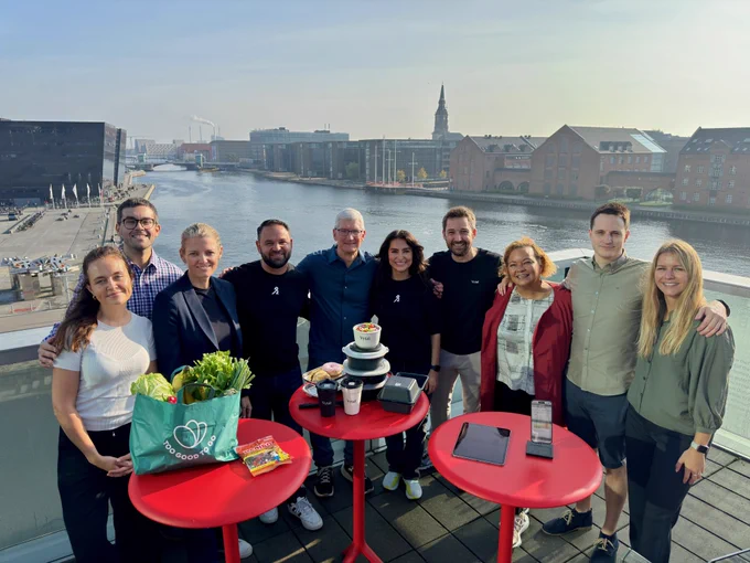 Tim and Apple’s Lisa Jackson take a group photo with developers with a canal in the background.