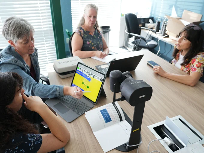 SET-BC vision group members at table testing MagniBot.