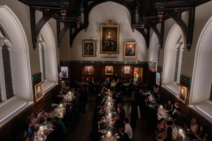 Orielenses seated along tables in College Hall at the Gaudy.