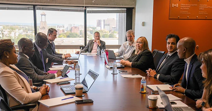 Representatives from OAPI and CIPO sitting at a table in a boardroom in discussion.