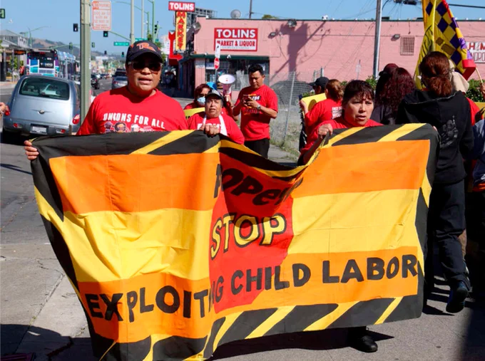 A picture of Striking Popeye’s workers in California carrying a sign that says “Stop Exploiting Child Labor”
More money, not pizza.