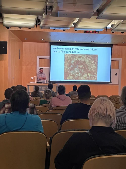 Postdoc George Brooks presents his research.