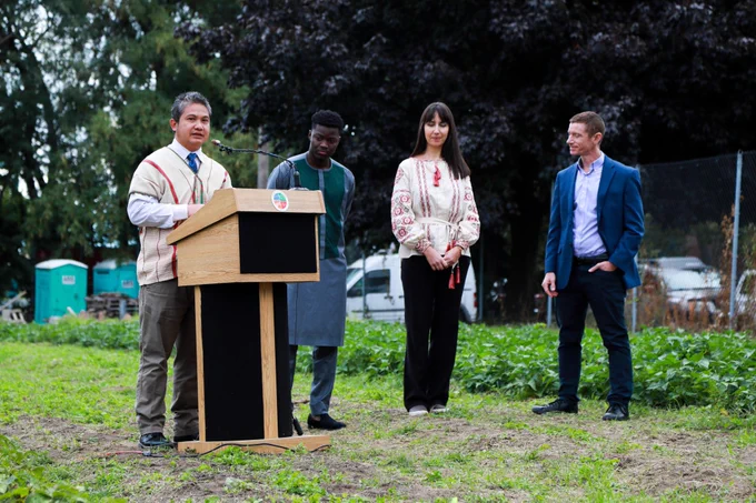 Khoon Thomas Kate, an immigrant from Thailand, speaks at the press event at Ohio City Farms during Global Cleveland’s Welcoming Week.
