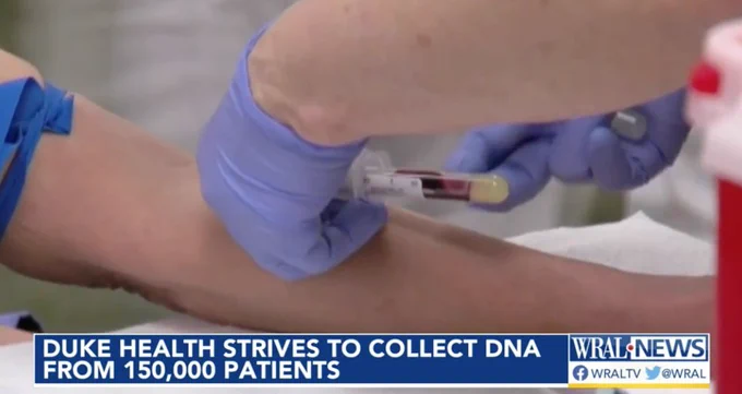 Caregiver draws blood from a patient's arm.