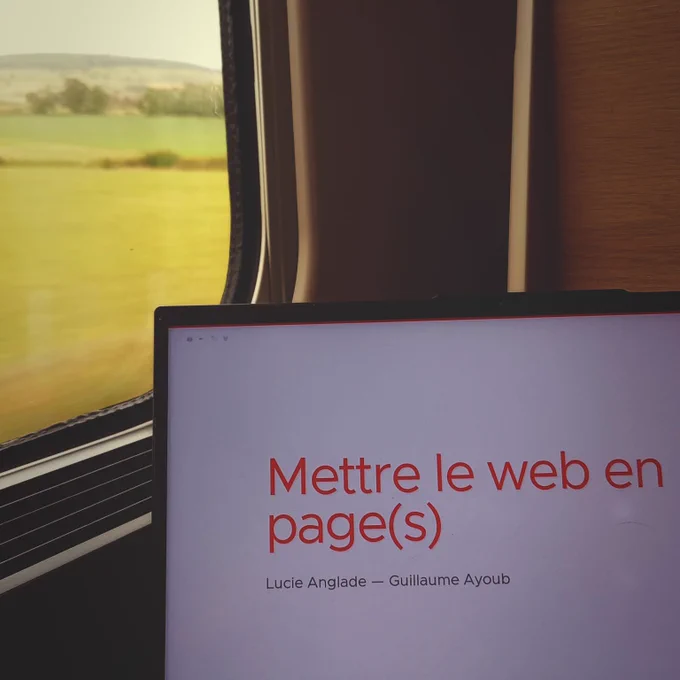 A computer on a train with a presentation displayed