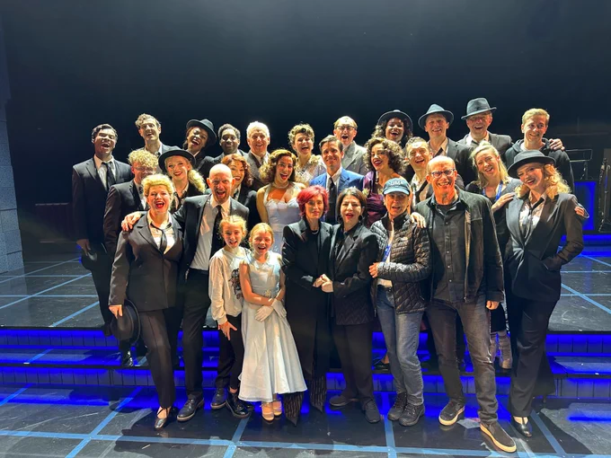 A group photo of the Sinatra cast with Tina Sinatra, Sharon Osborne, Michelle Anthony, and Bruce Resnikoff. They are all standing on The Rep stage posing for the camera.