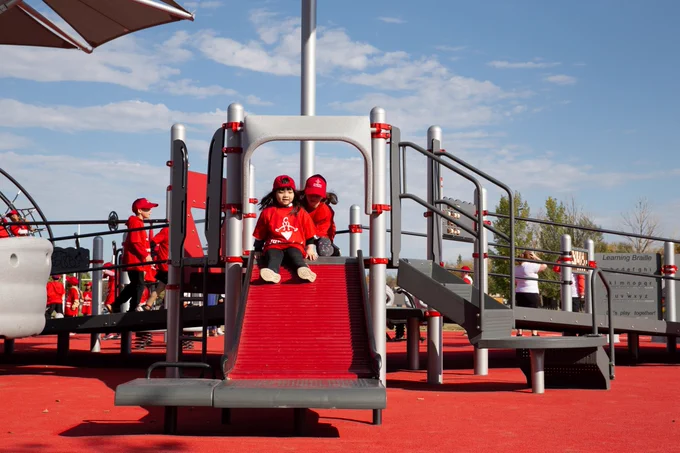 Picture features kids wearing Jumpstart branded clothing play at a Jumpstart Inclusive Play Space.