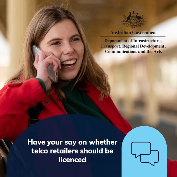 Woman at train station talking on mobile phone.