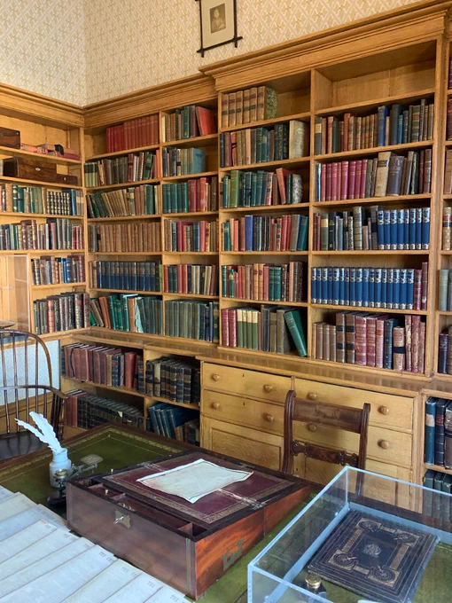 Book shelves filled with books in the Elizabeth Gaskell House museum.