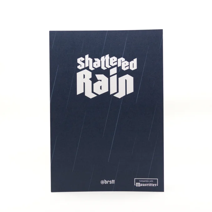 Shattered Rain cover, featuring the title in gothic-style font over a dark blue background with falling rain