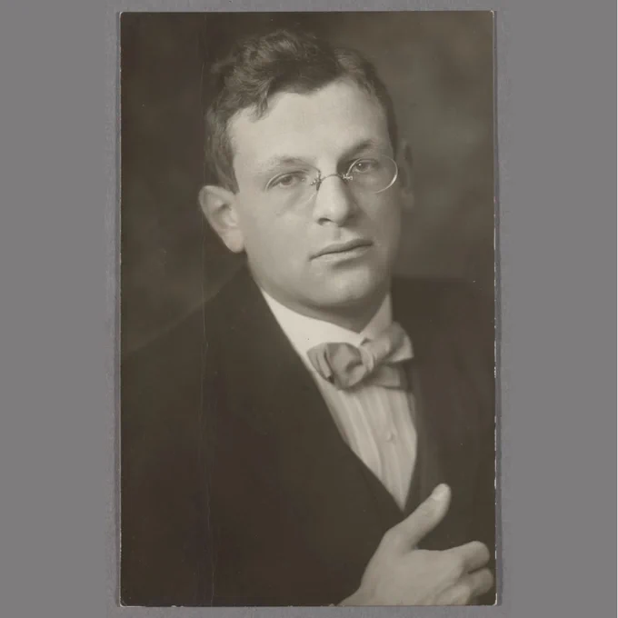 Black and white photographic postcard portrait of F. Charles Adler (1889-1959), conductor of the camp orchestra, taken at Ruhleben Internment Camp, Spandau, Germany, ca 1914-1918. HOLLIS olvwork425890