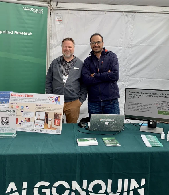 Jed and Adesh behind their booth. 