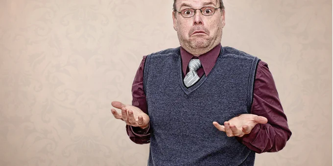 Man in business clothes shrugging because he has no idea how to determine his database recovery point objective or even what that means