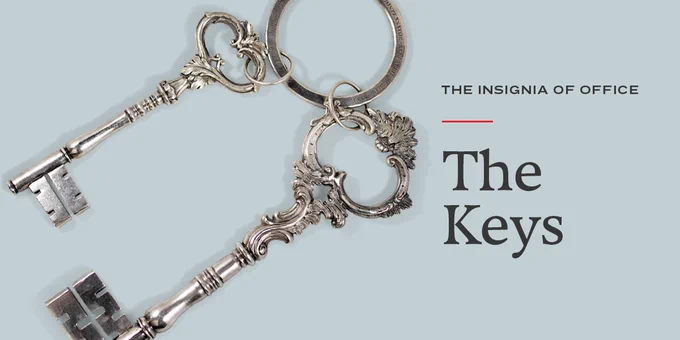 Two large silver keys on a key ring. Next to the keys, words read, "The Insignia of Office. The Keys"